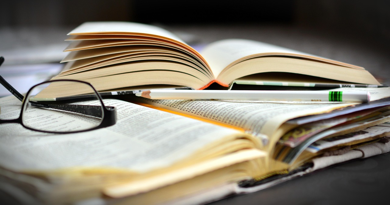 open books and a pair of glasses open books and a pair of glasses